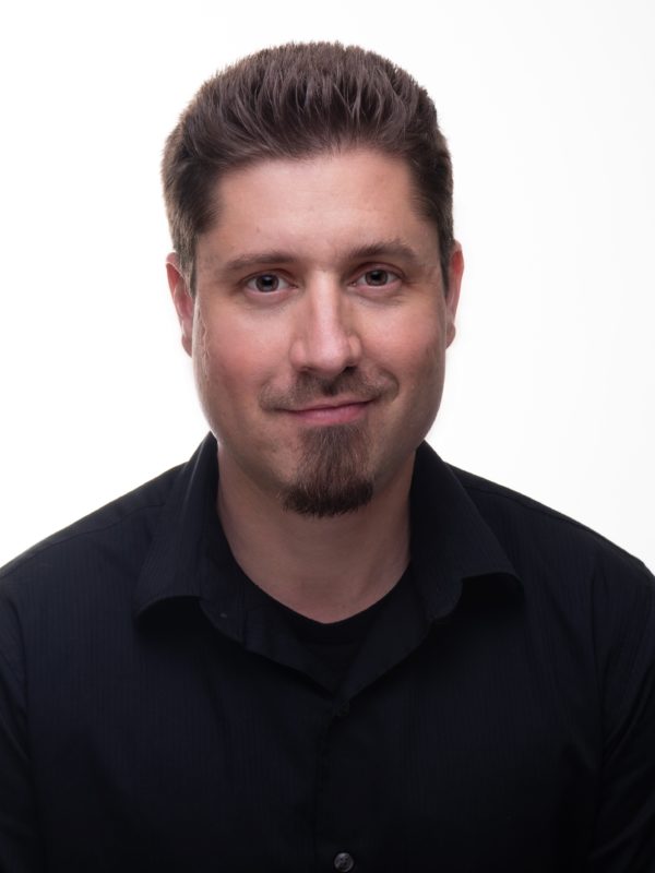 smiling light-skinned man with dark hair and goatee