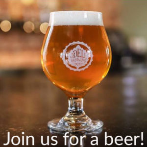 Beer in a glass with text under saying "join us for a beer"